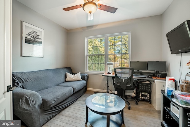 office area with ceiling fan, baseboards, and light wood-style flooring