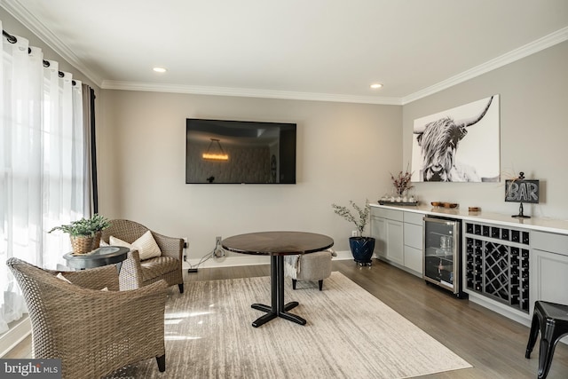 interior space featuring wine cooler, dark wood finished floors, a dry bar, and crown molding