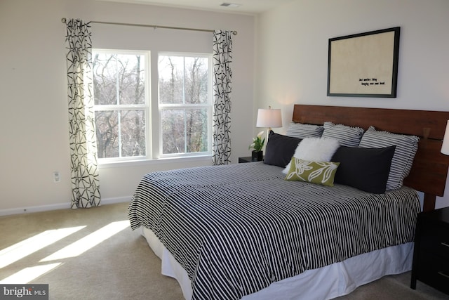 bedroom with baseboards, carpet floors, and visible vents