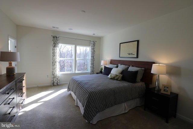 bedroom featuring visible vents, baseboards, and carpet floors