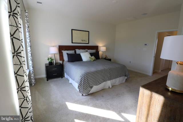 carpeted bedroom with visible vents and baseboards