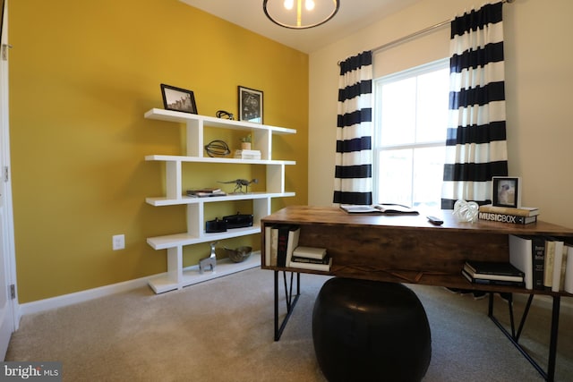 carpeted home office with baseboards