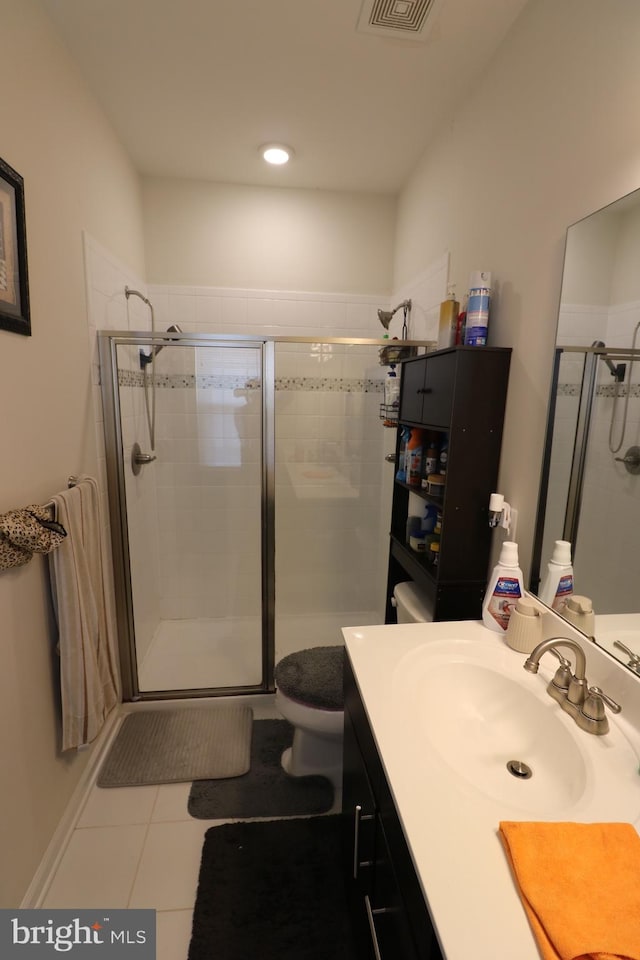 full bath with vanity, tile patterned floors, toilet, and a shower stall