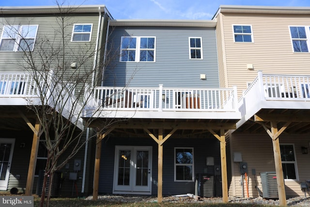 rear view of property with a deck and central AC