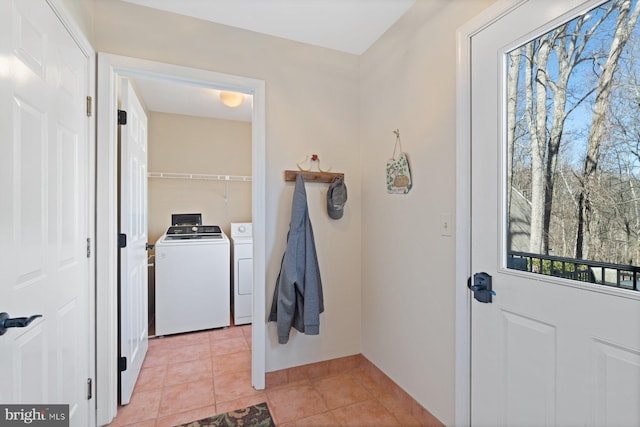 interior space with washer and dryer and light tile patterned flooring