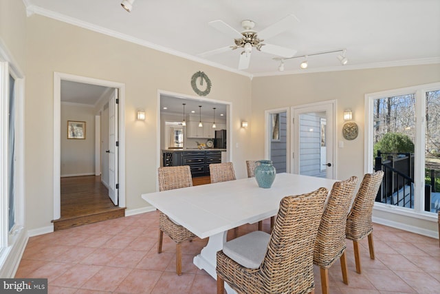 dining room with crown molding, ceiling fan, baseboards, lofted ceiling, and light tile patterned floors