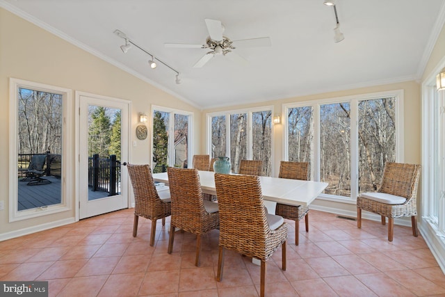 sunroom with visible vents, plenty of natural light, a ceiling fan, and vaulted ceiling