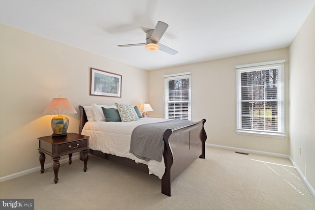 bedroom with visible vents, ceiling fan, baseboards, and carpet