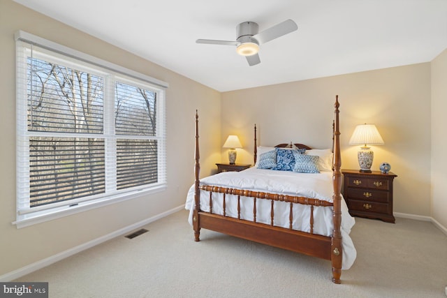 carpeted bedroom featuring visible vents, baseboards, and a ceiling fan