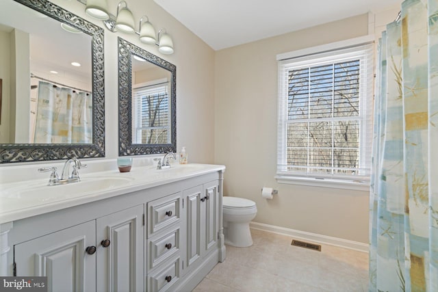 bathroom with plenty of natural light, visible vents, and a sink