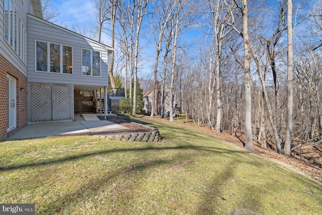 view of yard featuring stairway and a patio