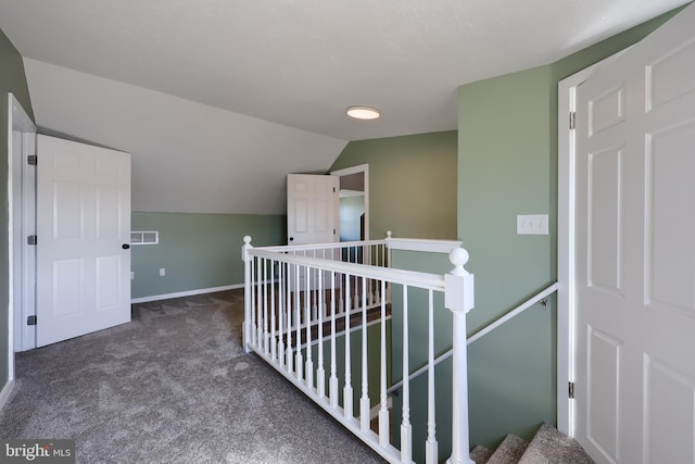 corridor with baseboards, lofted ceiling, an upstairs landing, and carpet flooring