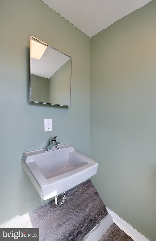 bathroom featuring wood finished floors and a sink