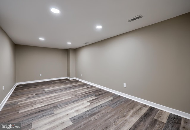 empty room featuring recessed lighting, visible vents, baseboards, and wood finished floors