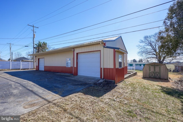 detached garage featuring fence