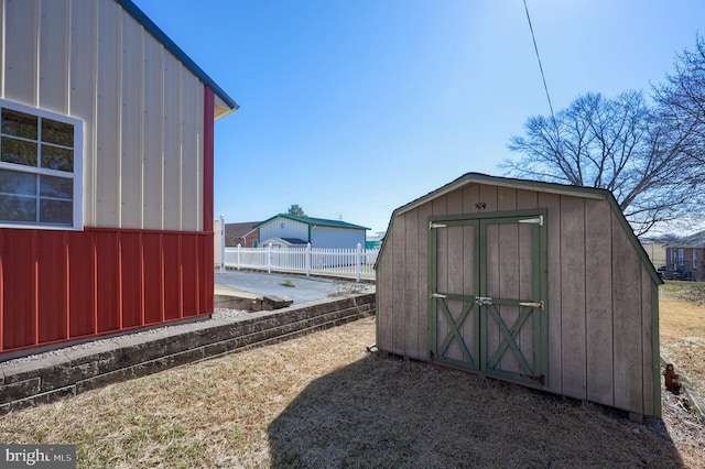 view of shed featuring fence