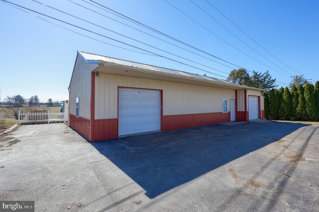 detached garage featuring fence