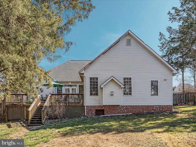 rear view of property with a wooden deck, stairs, a yard, and fence