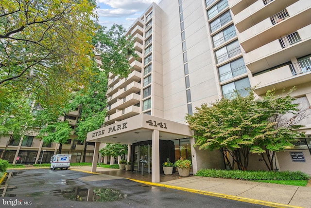 view of building exterior featuring uncovered parking