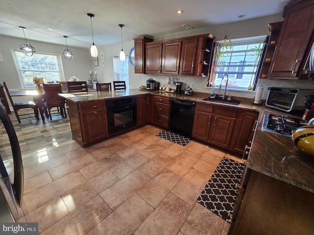 kitchen featuring tasteful backsplash, a peninsula, black appliances, open shelves, and a sink