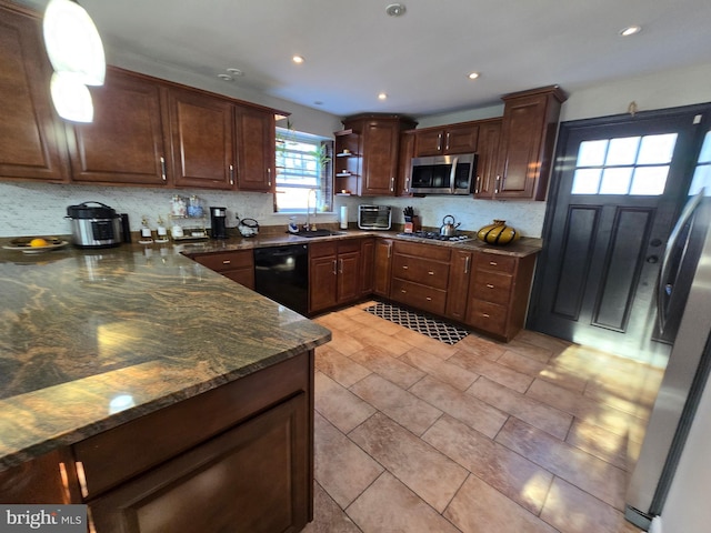 kitchen with open shelves, decorative backsplash, appliances with stainless steel finishes, a sink, and dark stone countertops