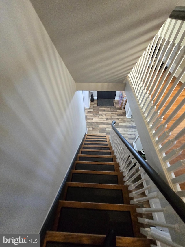 stairs with a textured ceiling