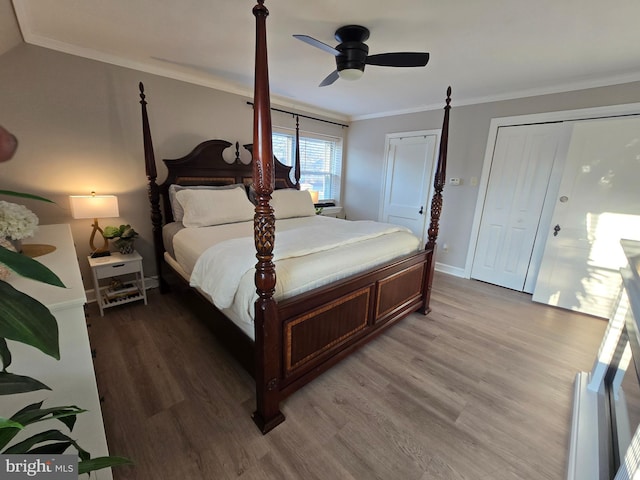 bedroom featuring light wood finished floors, ceiling fan, baseboards, and crown molding