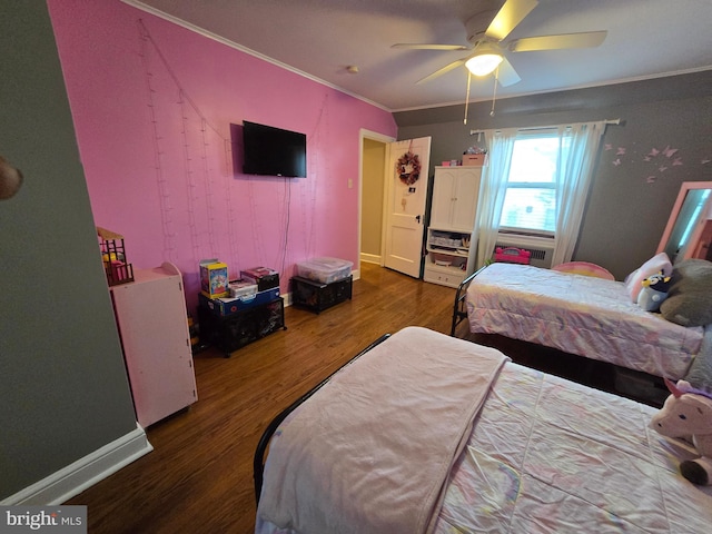 bedroom featuring ornamental molding, ceiling fan, baseboards, and wood finished floors