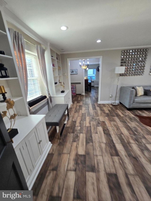 hall with ornamental molding, dark wood-style flooring, recessed lighting, and an inviting chandelier