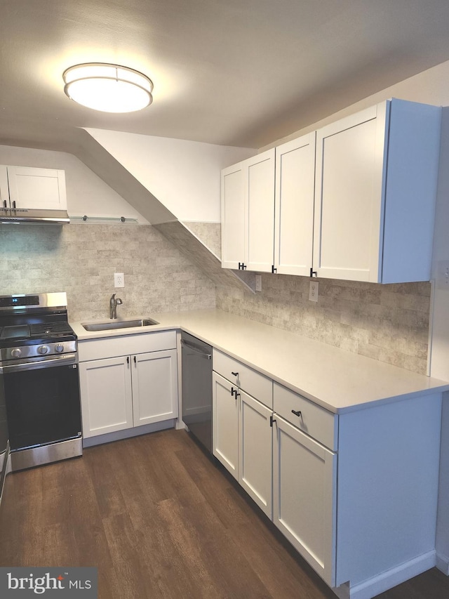 kitchen with appliances with stainless steel finishes, light countertops, a sink, and decorative backsplash