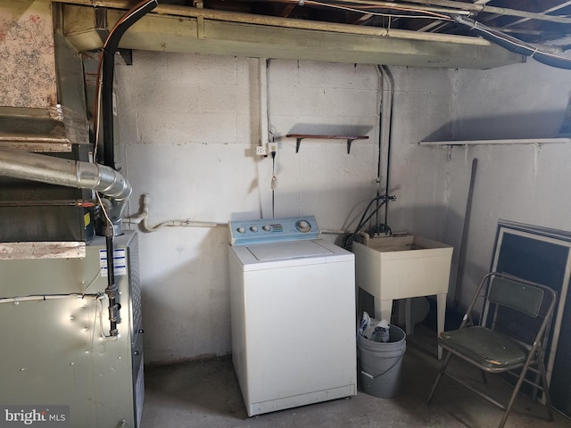 laundry room with laundry area, washer / clothes dryer, and a sink