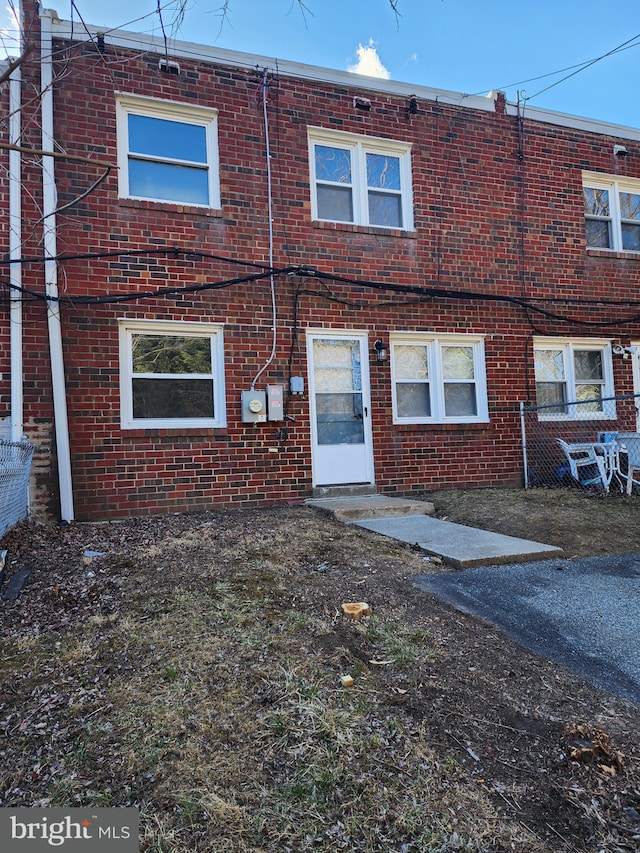 back of house featuring brick siding