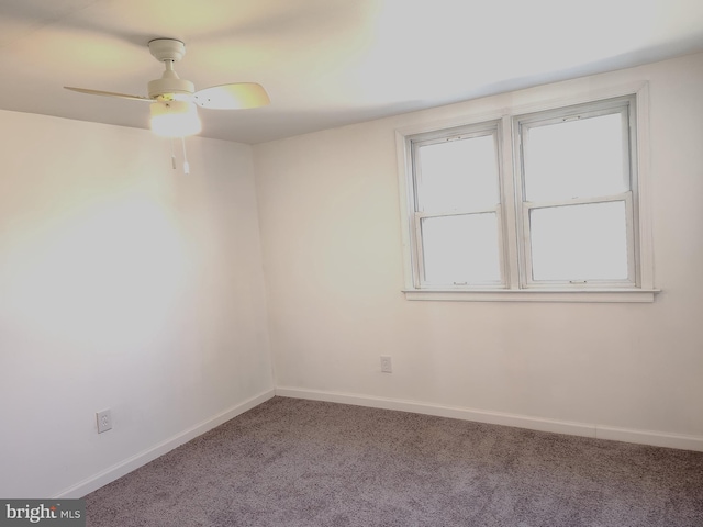 unfurnished room featuring carpet floors, ceiling fan, and baseboards