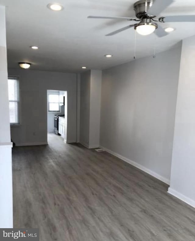 unfurnished room with ceiling fan, recessed lighting, wood finished floors, and baseboards