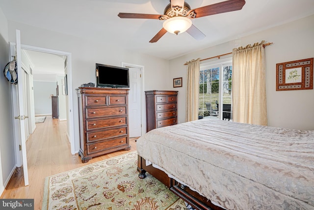 bedroom featuring a ceiling fan, baseboards, and light wood finished floors