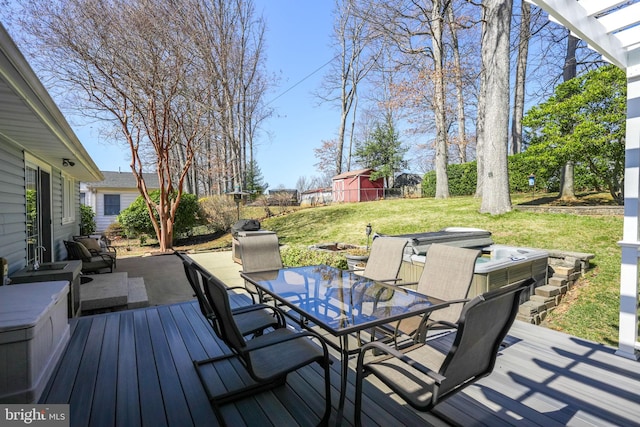 wooden terrace featuring outdoor dining space, a patio, a jacuzzi, and a lawn