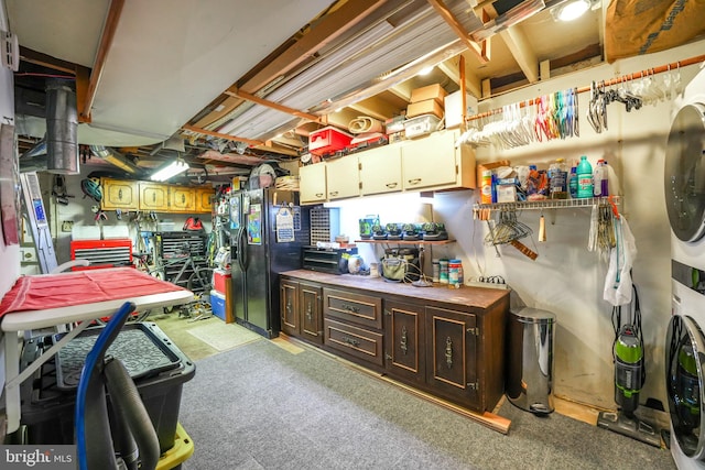 interior space featuring dark brown cabinetry, washer / dryer, and black refrigerator with ice dispenser