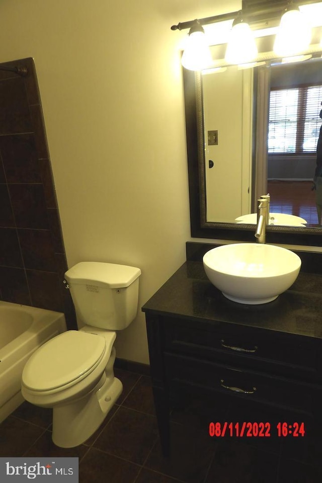 full bathroom with a bathtub, tile patterned flooring, vanity, and toilet