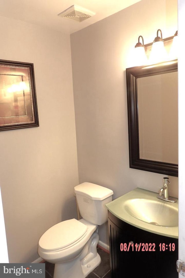 bathroom featuring toilet, visible vents, and vanity