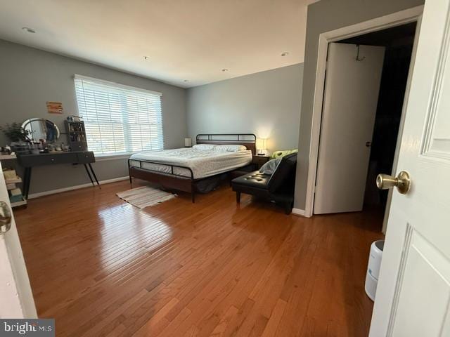 bedroom with wood finished floors and baseboards