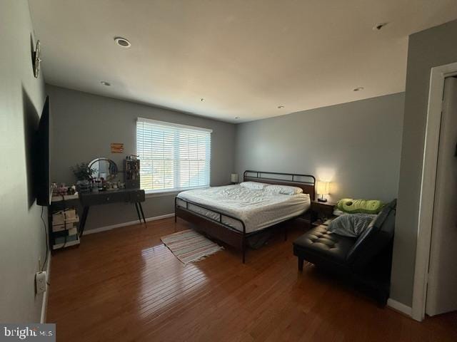 bedroom featuring wood finished floors and baseboards