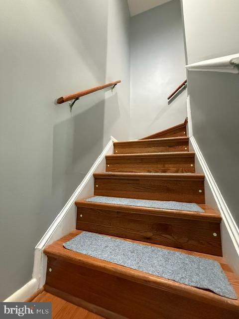 stairway with wood finished floors