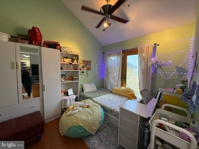 bedroom featuring ceiling fan, high vaulted ceiling, and wood finished floors