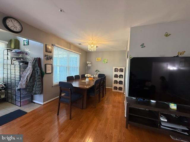 dining space featuring baseboards and wood finished floors