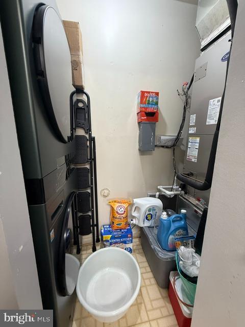 interior space with laundry area and stacked washer / drying machine