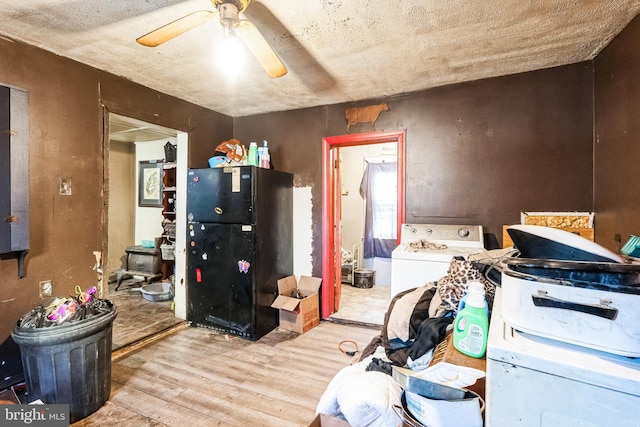 kitchen featuring ceiling fan, washer / dryer, and wood finished floors