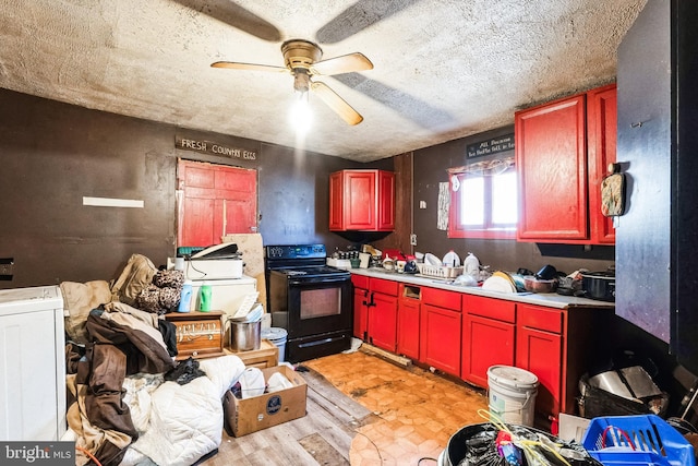 kitchen featuring a ceiling fan, washer / clothes dryer, light countertops, a textured ceiling, and black electric range oven