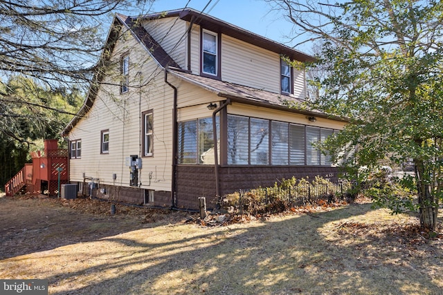 view of home's exterior with a sunroom