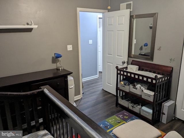 bedroom featuring baseboards, visible vents, and dark wood-style flooring