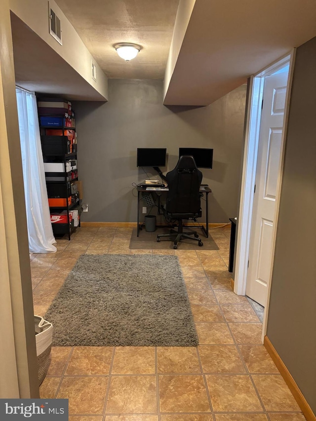 office featuring visible vents, baseboards, and light tile patterned floors